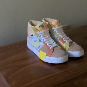Orange and yellow Nike high tops with white laces